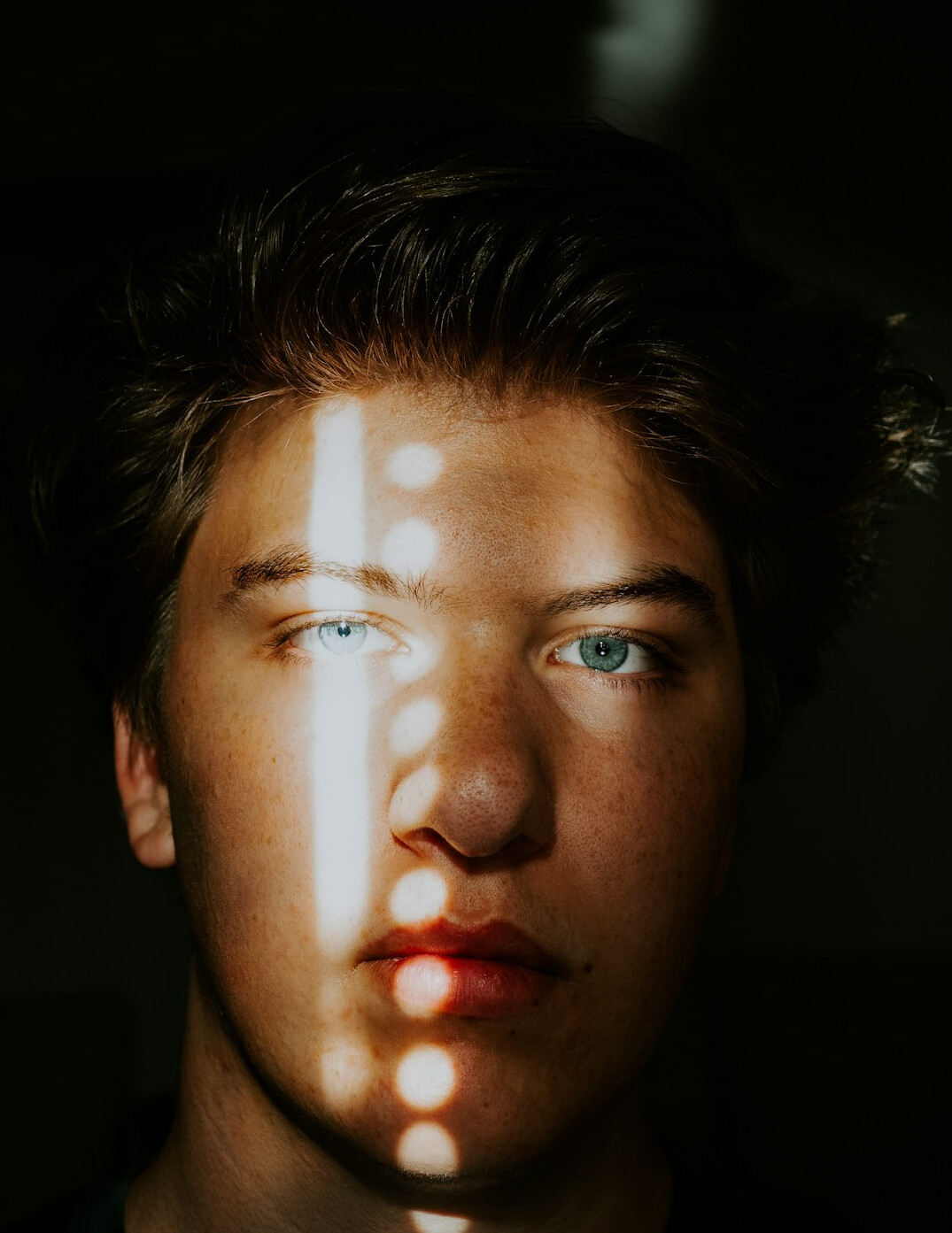 Portrait of a young man in a shirt looking at the camera