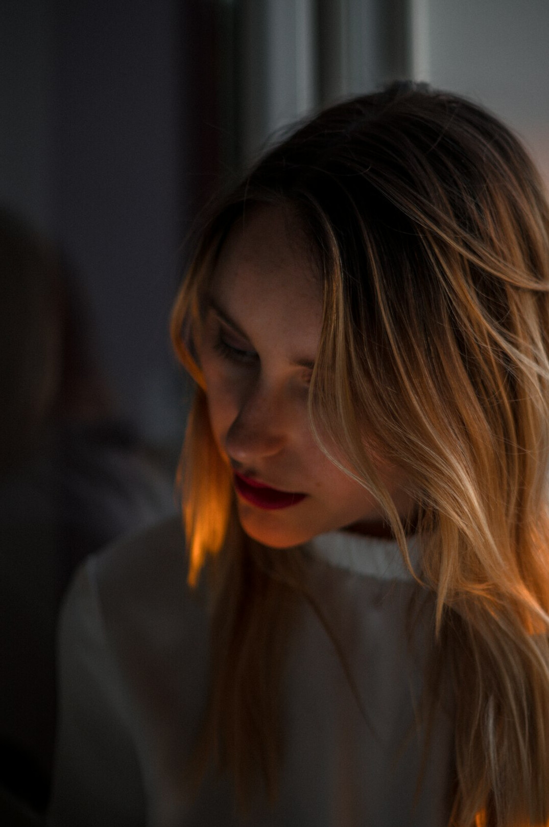 Portrait of a woman with light hair smiling softly