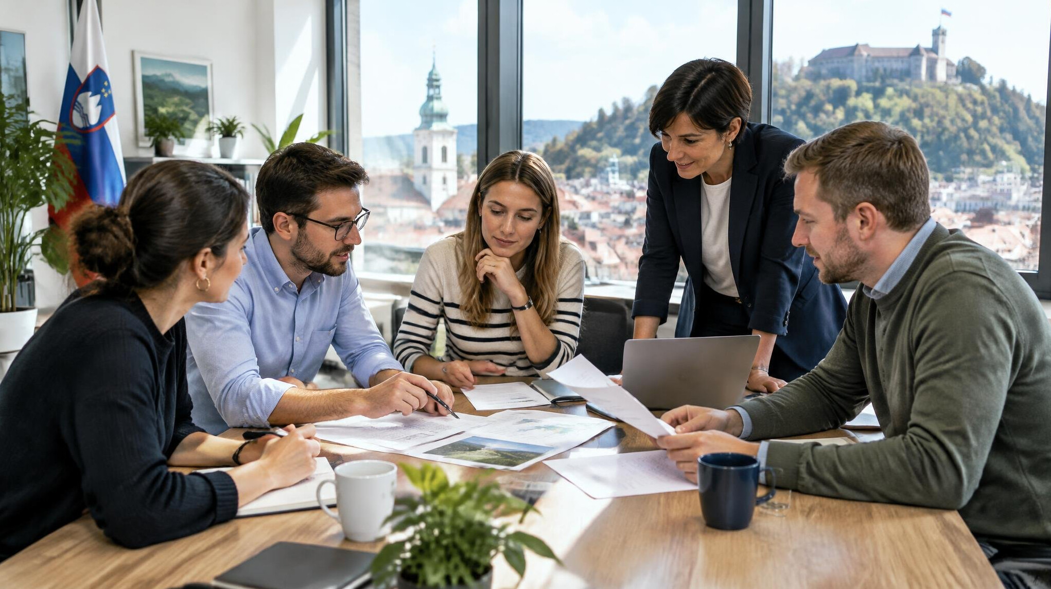 Group of colleagues collaborating around a table in a bright office