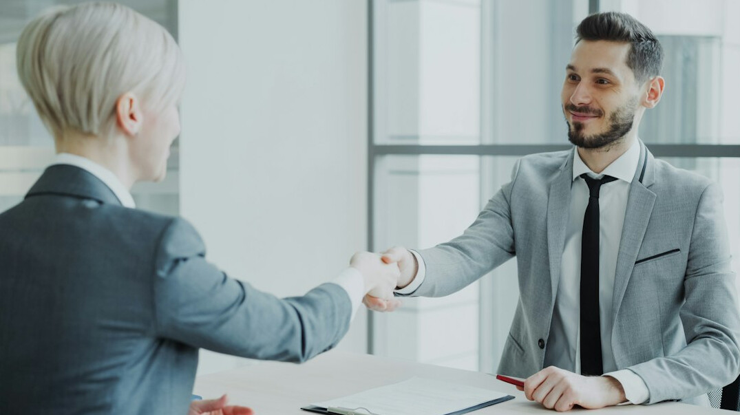 business handshake in office